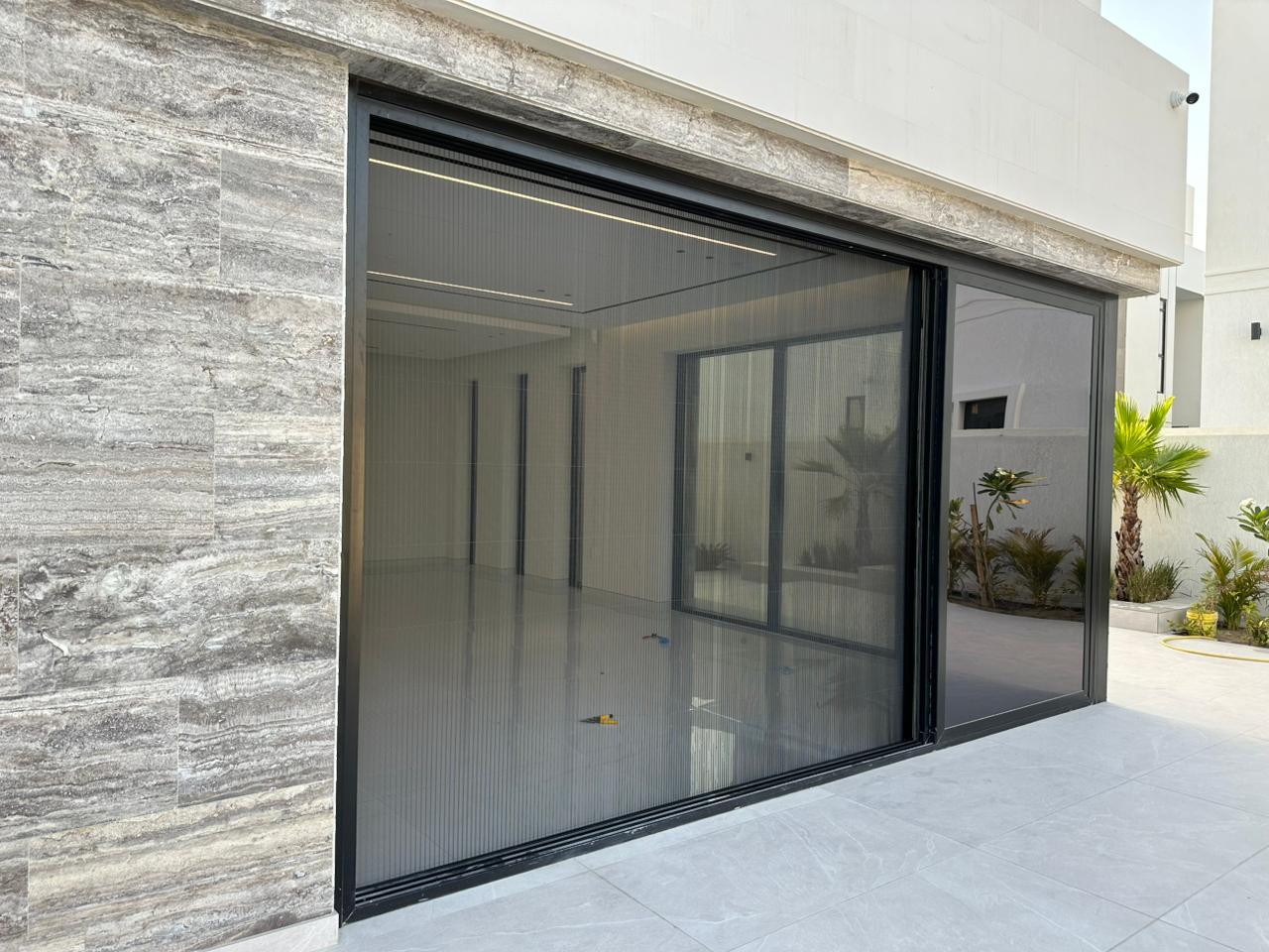 Custom fly screen on District One mansion bedroom window overlooking 7km Crystal Lagoon, dark grey mesh white frame, Dubai UAE