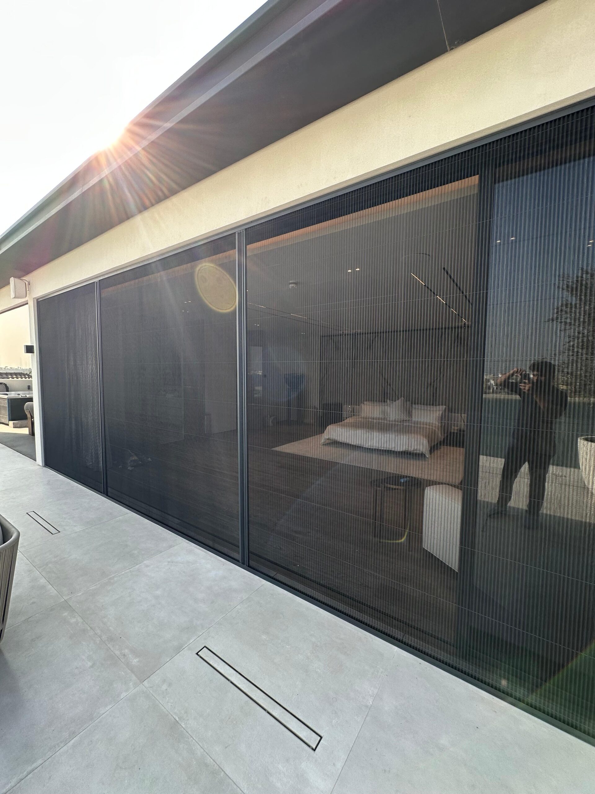Custom fly screen on Tilal Al Ghaf bedroom window overlooking lagoon, dark grey mesh white frame, Dubai UAE