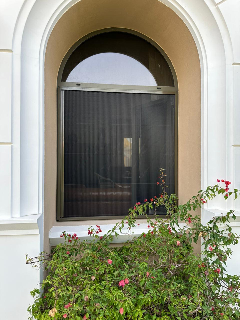 Double fly screen brown bronze custom aluminium frame arched window dark mesh Dubai villa