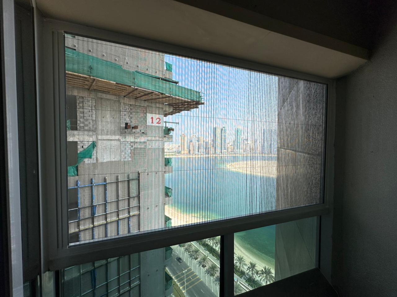 Retractable fly screen installed on a casement window in a Dubai villa with aluminium frame and mesh