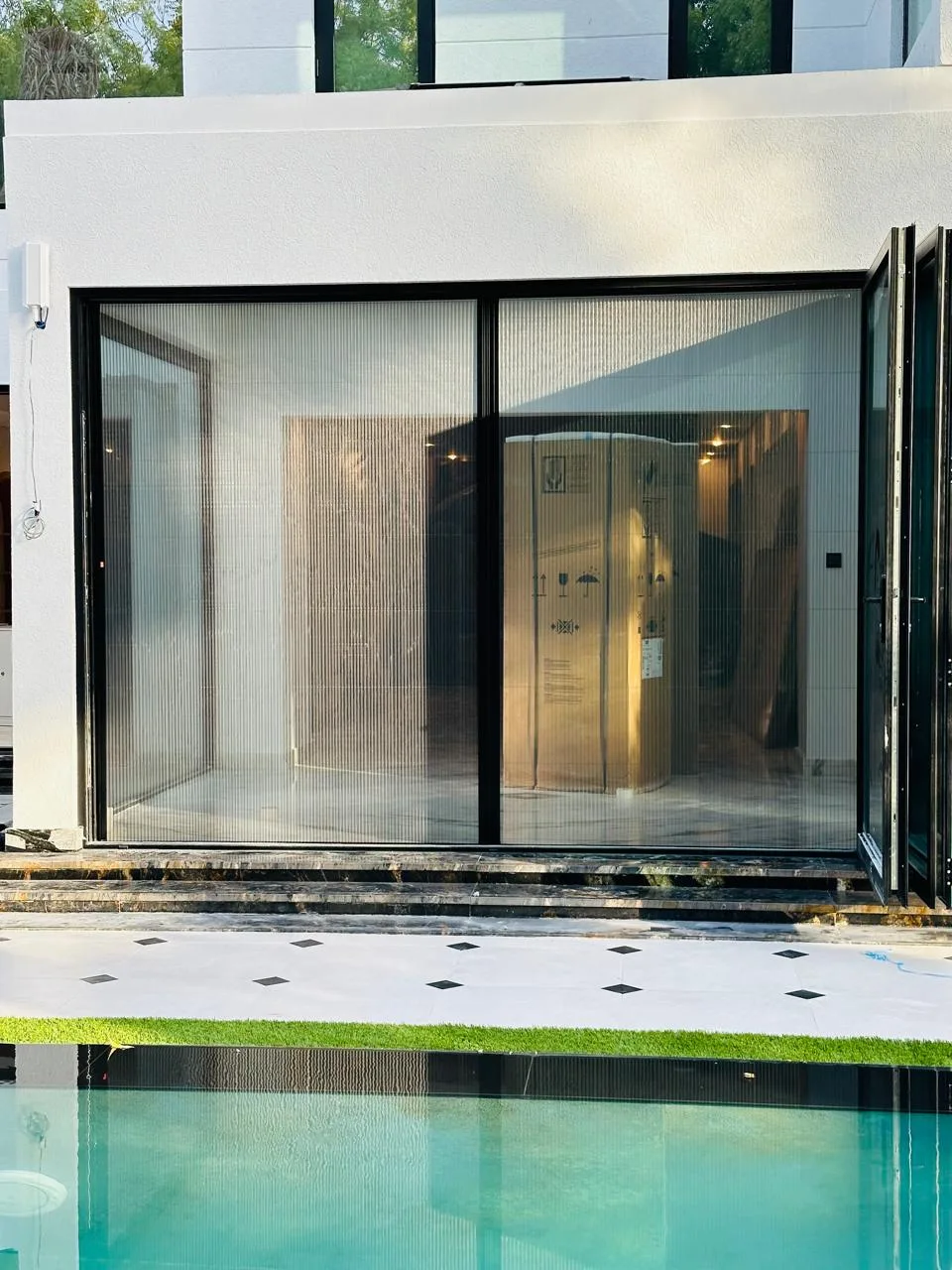 Custom retractable pleated fly screen installed on a wide Dubai villa window
